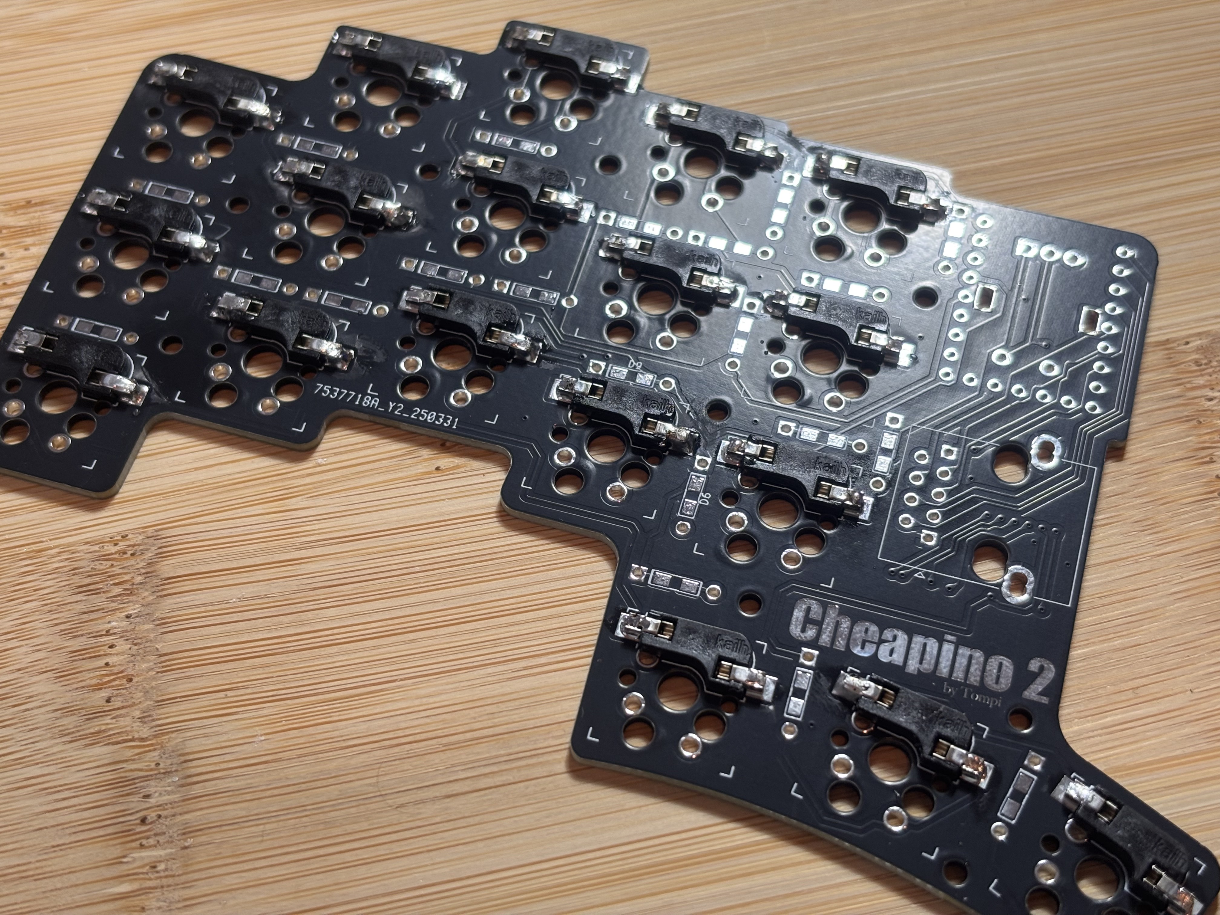 A black PCB with hotswap sockets soldered into it